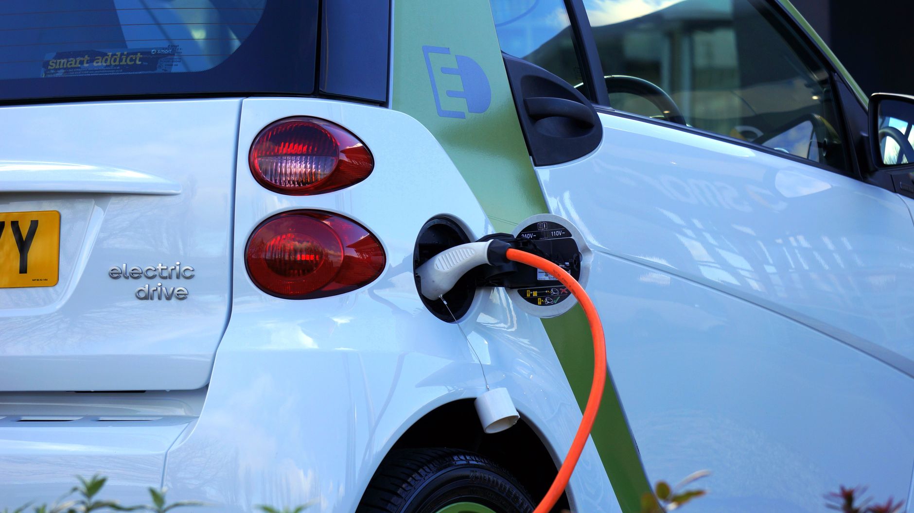 Zbliżenie na ładowanie używanego auta elektrycznego przy stacji